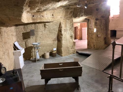 a stone room with a chest in the middle of it at Casa Camilla in Massafra