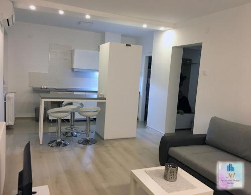 a living room with a couch and a kitchen at 3M Apartment Skopje Center in Skopje