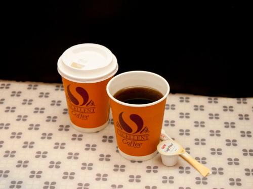 two cups of coffee sitting on top of a table at Smile Hotel Otsu Seta in Otsu