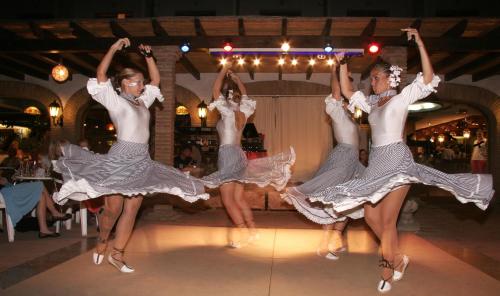 three young women are dancing in a room at Hotel Apartamentos Bajondillo in Torremolinos