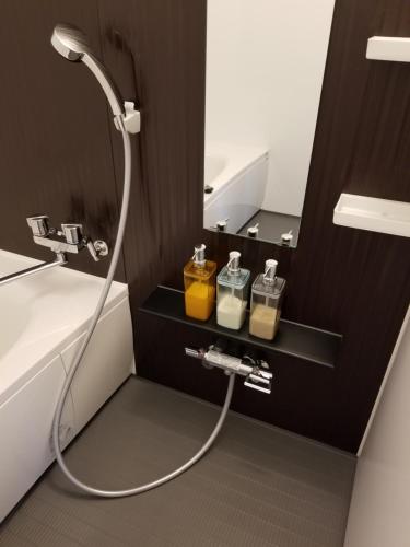 a bathroom with a shower and a sink and a mirror at Furano Mount Villa in Furano