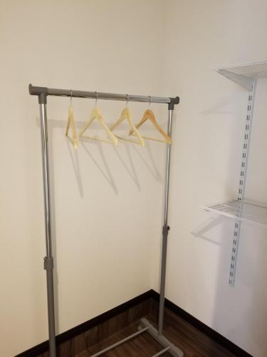 a metal rack with hangers in a room at Furano Mount Villa in Furano