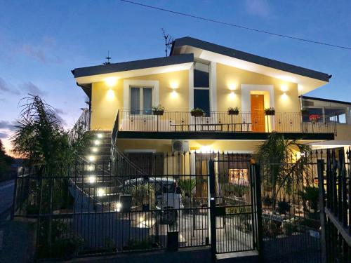 a white house with lights on the stairs at B & B Il Giardino sul Mare in Briatico