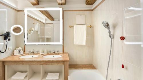 a bathroom with a sink and a shower at Radisson Blu Hotel Altstadt in Salzburg