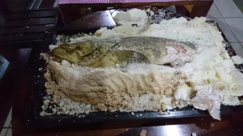 a fish sitting on a plate with snow at La Maison in Toamasina
