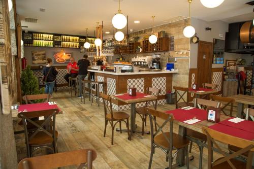 a restaurant with tables, chairs, and tables in it at JC Rooms Chueca in Madrid
