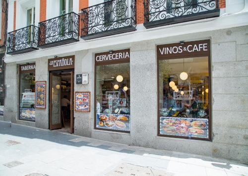 a store front of a building with a bunch of windows at JC Rooms Chueca in Madrid