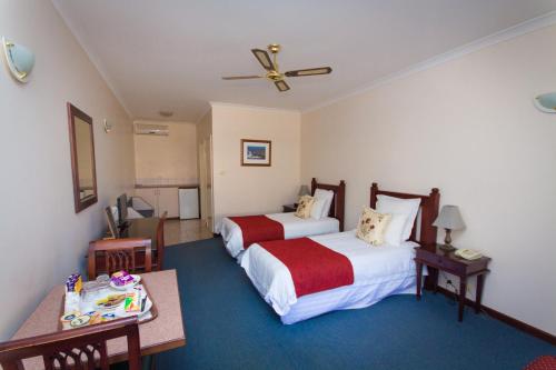 a hotel room with two beds and a table at Tree Top Walk Motel in Walpole