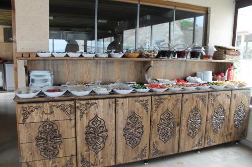 a buffet line with bowls and plates of food at Relic House in Goreme