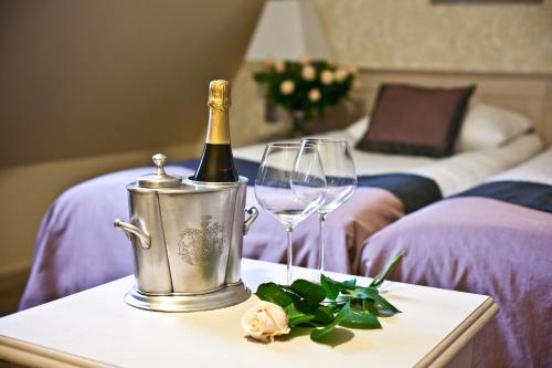 a bottle of champagne and a glass on a table at Zamek Topacz in Wrocław