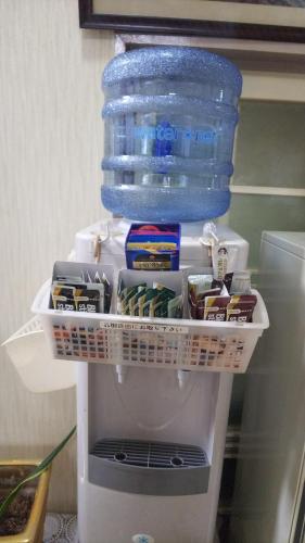 a refrigerator filled with food and a bottle of water at Business Hotel Seifusou in Saiki