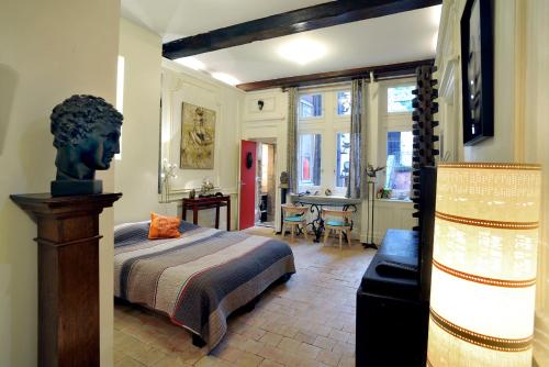 a bedroom with a bed and a dresser at Chambres d'hôtes Artelit in Lyon