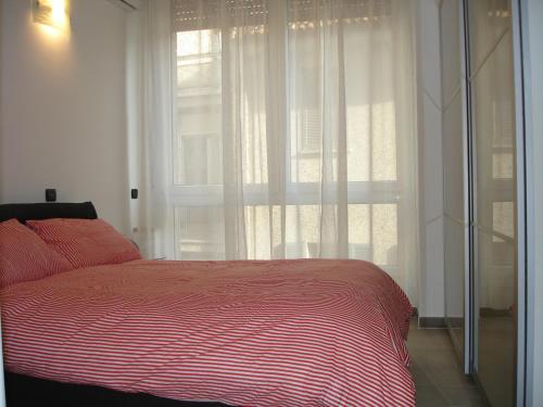 a bedroom with a bed and a large window at Milan City Center Apartment in Milan