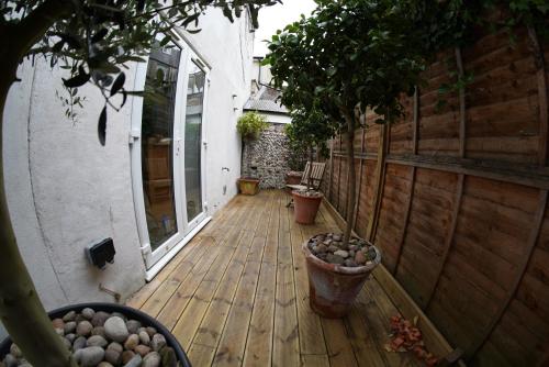una terraza de madera con macetas en una casa en Central Townhouse & Terrace, en Brighton & Hove