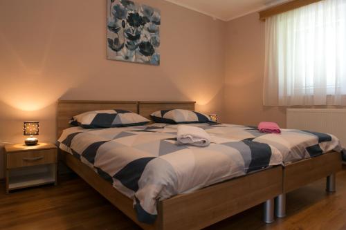 a bedroom with a large bed with two pillows at Rooms Ivan in Otočac