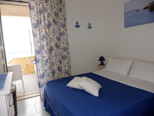 a bedroom with a blue bed with a pillow on it at Pietra di Luna a...mare in Polignano a Mare