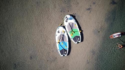 an overhead view of two surfboards on the beach at The Husky House or Little Husky Studio Suite in Huskisson