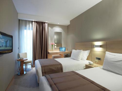 Ένα ή περισσότερα κρεβάτια σε δωμάτιο στο Anatolia Hotel Komotini 