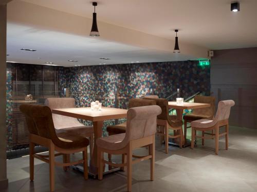 a dining room with two tables and chairs at Anatolia Hotel Komotini in Komotini