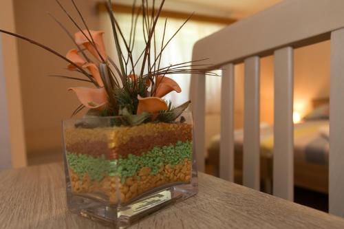 a vase with plants in it sitting on a table at Rooms Ivan in Otočac