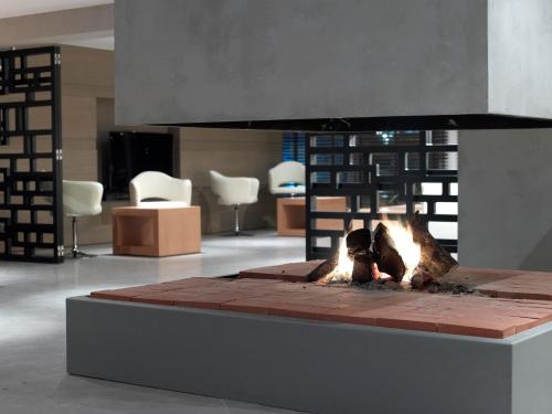 a fire pit in the middle of a room at Anatolia Hotel Komotini in Komotini