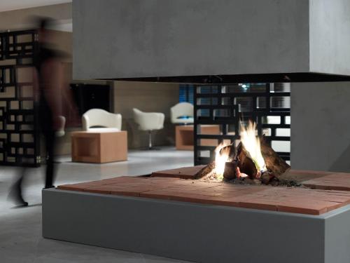 a fireplace in a room with a fire pit at Anatolia Hotel Komotini in Komotini