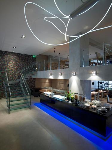 a large kitchen with a counter and a staircase at Anatolia Hotel Komotini in Komotini
