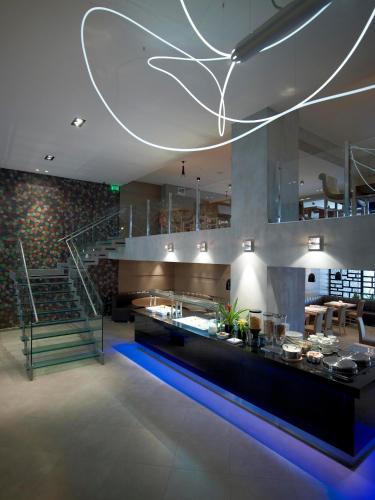 a large kitchen with a counter and a staircase at Anatolia Hotel Komotini in Komotini