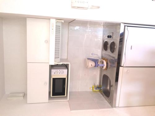 a small kitchen with a sink and a refrigerator at Résid'Artel Cadarache - ITER in Saint-Paul-lez-Durance