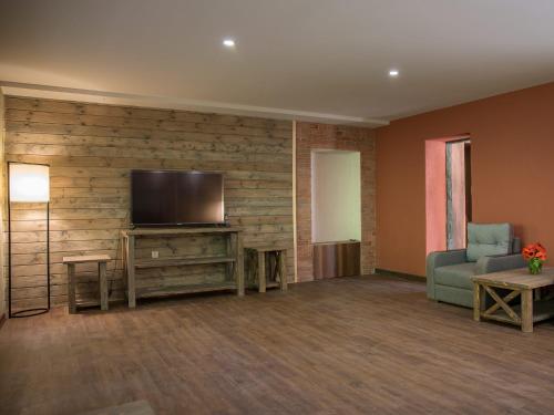 a living room with a flat screen tv on a wall at Apricot Aghveran Resort in Agveran