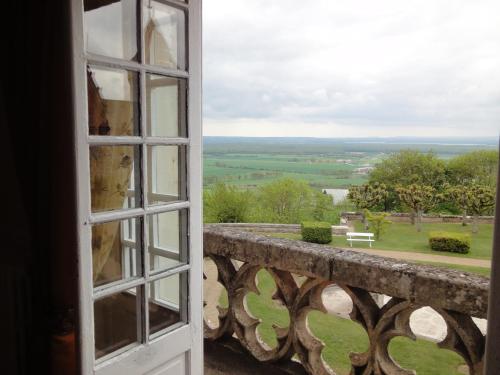 an open door looking out at a view of a field at Hattonchatel Château & Restaurant La Table du Château in Hattonchâtel