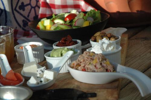 a table topped with bowls of food and a salad at Rom HaTayelet in Arad