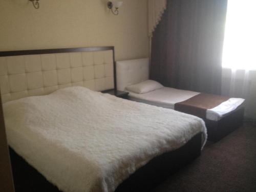 Кровать или кровати в номере Elion Hotel