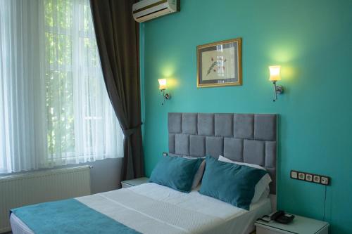 Кровать или кровати в номере Hotel Tulip House