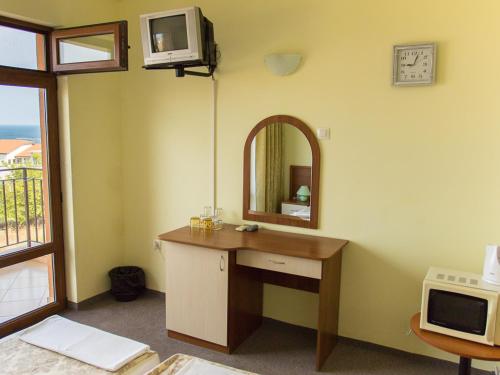 a bathroom with a sink and a mirror on the wall at Villa Iztok in Sozopol