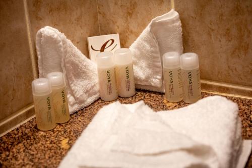 a group of bottles sitting on a counter with towels at Kilkenny Inn in Kilkenny