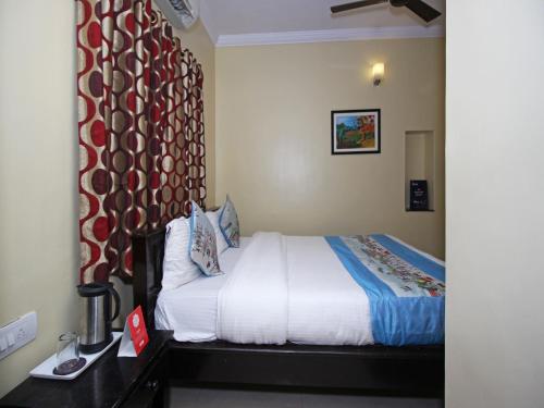 a hotel room with a bed and a window at Hotel Ajit Mansion in Jodhpur