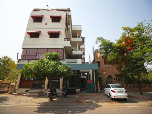 a white car parked in front of a building at Hotel Ajit Mansion in Jodhpur