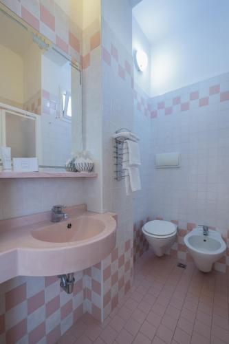 a bathroom with a sink and a toilet at Hotel San Paolo in Rimini