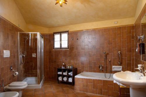 a bathroom with a toilet and a shower and a sink at La Bagnaia Golf Resort in Bagnaia