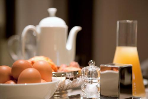 un tavolo con una ciotola di uova e una brocca di latte di Storni Barcelona a Barcellona