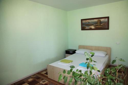 a bedroom with two beds and a picture on the wall at Guest House Lanka in Golubitskaya