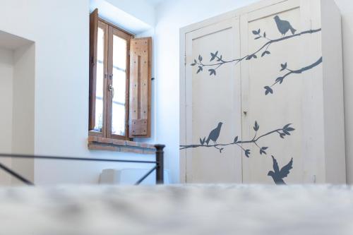 a room with a door with birds on a wall at Agriturismo Casa Vecchia in Morcella