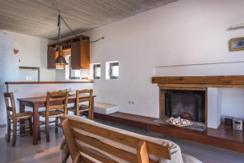 a living room with a table and a fireplace at Red Art Maisonette in Kardhakáta