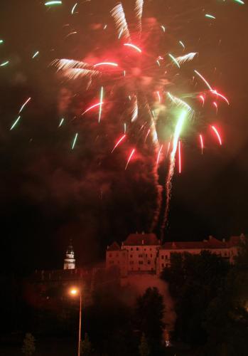 a firework display in the sky over a city at The best CASTLE VIEW-bus station, parking, center in Český Krumlov