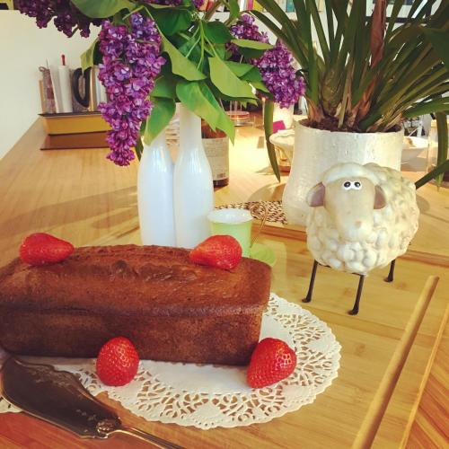 a cake on a table with strawberries on a plate at Hôtel Bosquet Pau Centre - Self Check In Budget Hotel in Pau