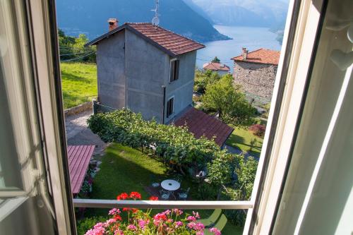 a view from a window of a garden and a building at Holiday Home Liliana in Faggeto Lario 