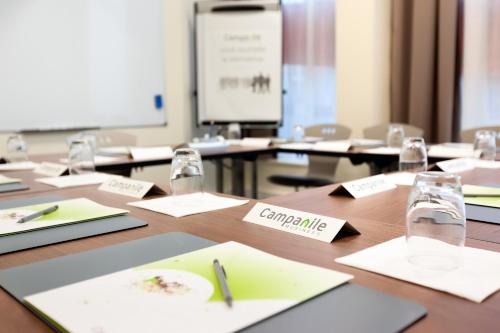 a conference room with a table with pens and glasses at Campanile La Roche Sur Yon Centre Gare in La Roche-sur-Yon