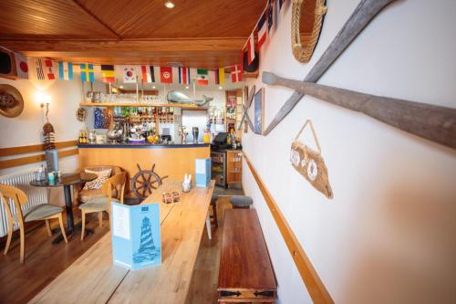 a restaurant with a table and a baseball bat on the wall at The Waterfront in Portpatrick
