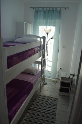 two bunk beds in a room with a window at Apartmani Juresko Mrljane in Mrljane